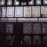 Mashrabiya or Shanasheel is the Arabic term given to a type of projecting oriel window enclosed with carved wood latticework located on the second storey of a building or higher; often lined with stained glass.  